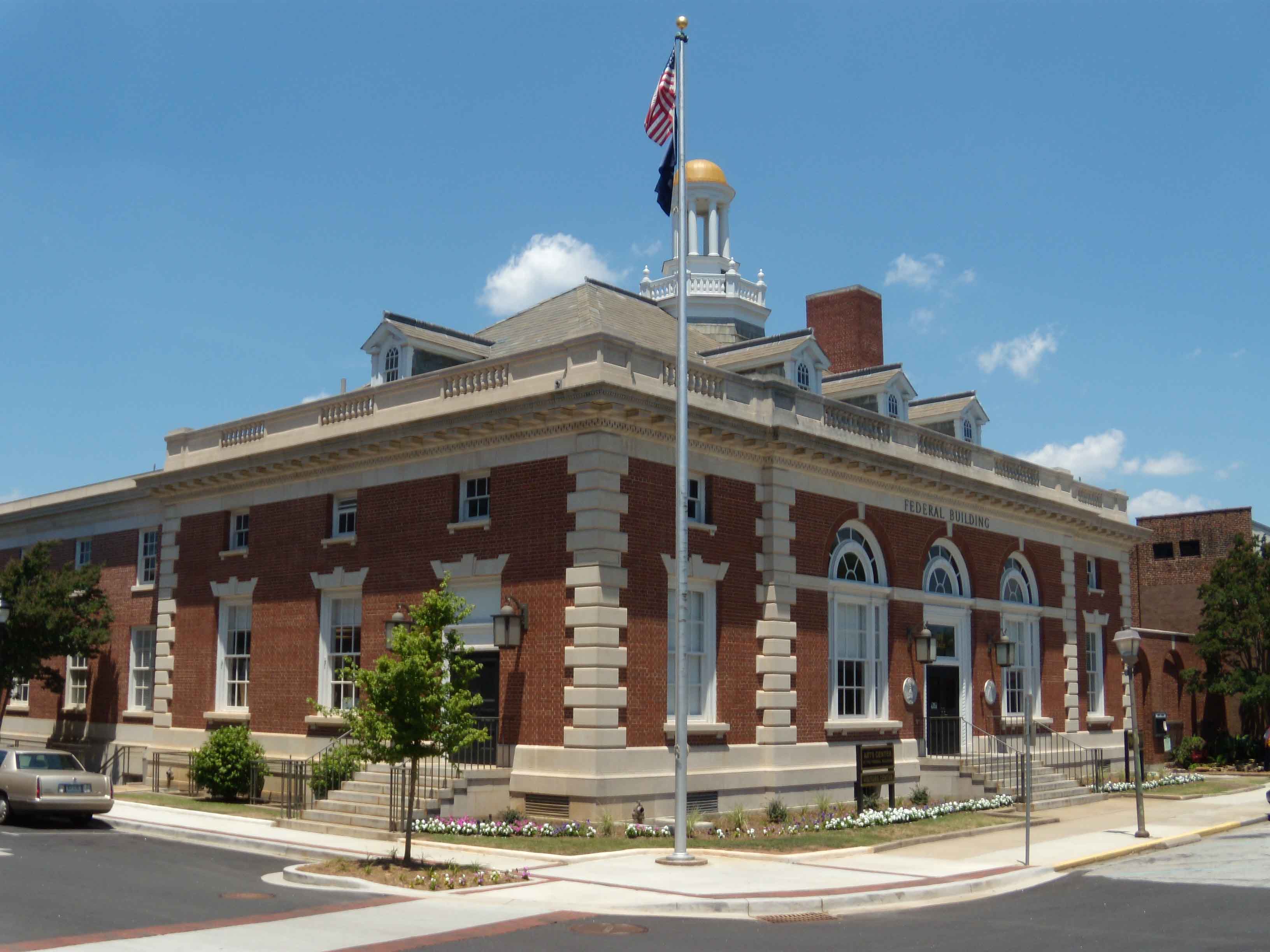 Greenwood federal building with flag pole and parking lot